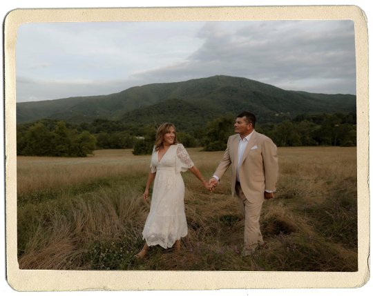 Thomas C. Smith and his wife, Meri, are photographed in front of a mountain scene.